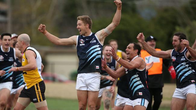 Ficorilli (second from right) was first to his great mate Kimpton after the 100th goal sailed through. Photo: Hamish Blair