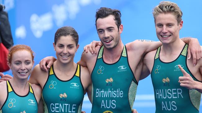 The Australian team of Charlotte McShane, left, Ashleigh Gentle, Jake Birtwhistle and Matthew Hauser celebrate winning the world mixed relay title in Hamburg