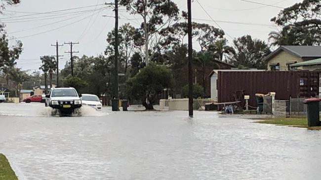 A 4WD drives along Wunda Ave at Sussex Inlet after flooding in late July. Picture: Sam Strong