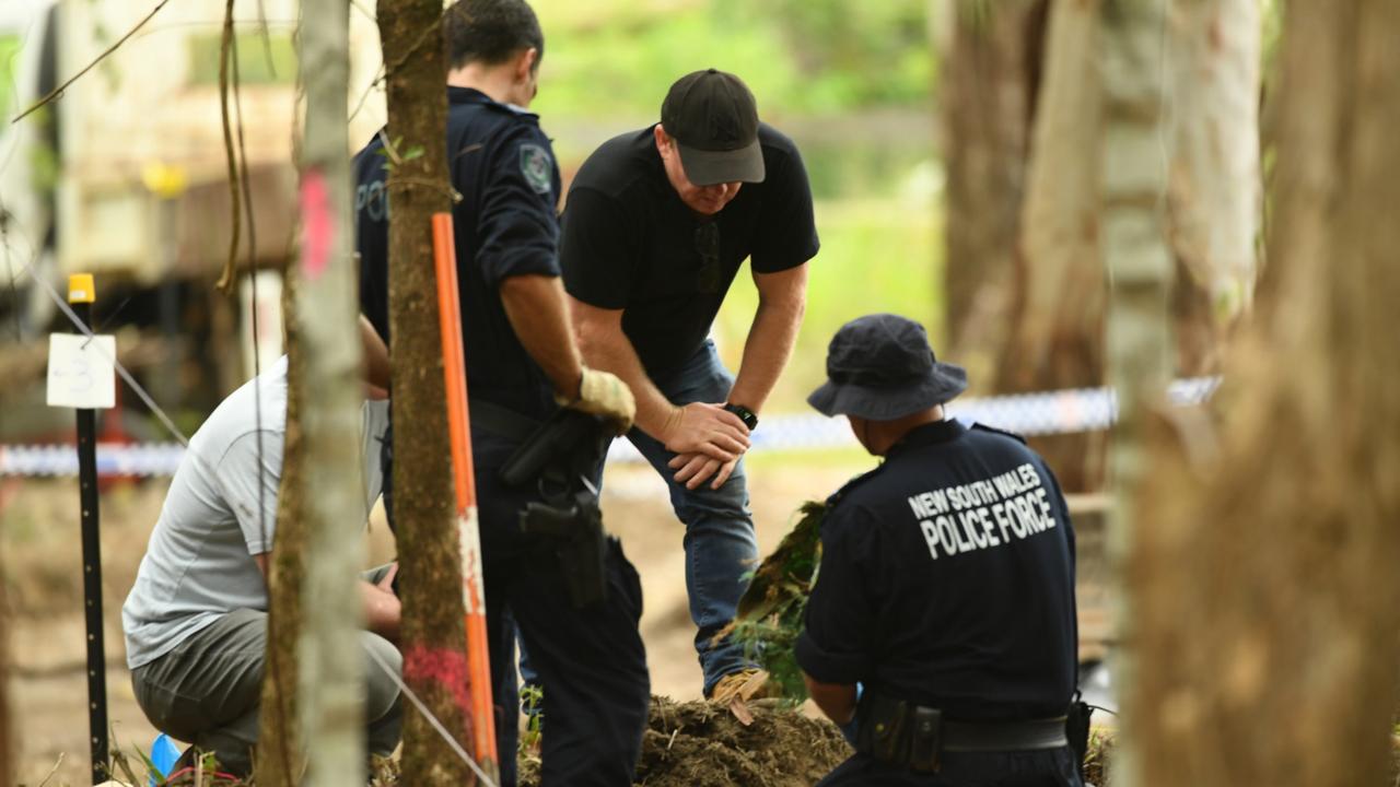 Detectives inspect a piece of green hessian recovered from dirt in scrub off Batar Creek Rd, less than 900m from the Tyrrell's former family home at Kendall. Picture NCA NewsWire/Trevor Veale