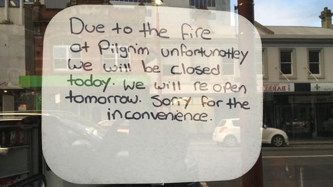 A sign of the window of Speed Feed takeaway, nearby Pilgrim Coffee, which has been forced to close after Monday night's devastating fire. Picture: SUSAN OONG