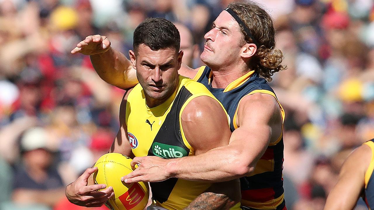 ADELAIDE, AUSTRALIA - MARCH 25: Jack Graham of the Tigers is tackled by Sam Berry of Adelaide during the 2023 AFL Round 02 match between the Adelaide Crows and the Richmond Tigers at Adelaide Oval on March 25, 2023 in Adelaide, Australia. (Photo by Sarah Reed/AFL Photos via Getty Images)