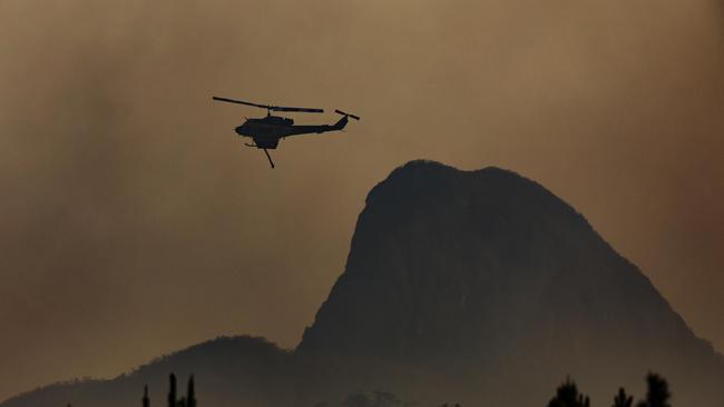 Water bombing helicopter helping to fight the fire in Landsborough late on Sunday afternoon. Picture Lachie Millard