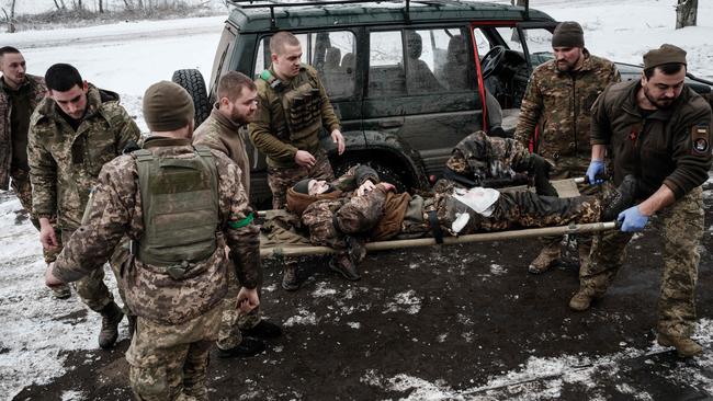 Paramedics carry a Ukrainian serviceman who stepped on a land mine in the Donetsk region on Sunday. Picture: AFP