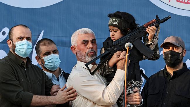 Yahya Sinwar holds the child of an Al-Qassam Brigades fighter who was killed in the 2021 fighting with Israel. Picture: AFP