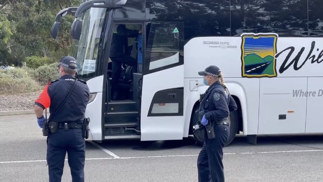 Police inspect the school bus at Victor Harbor following the feared Covid-19 breach. Picture: Gary Juleff