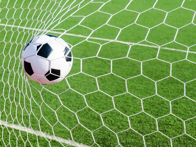 Image of Soccer football in Goal net with green grass field. For sport concept.