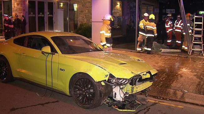 A 42-year-old man is facing a hefty damage bill after crashing his Ford Mustang into a barber shop at Norwood. Picture: 7NEWS