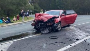 Red Mazda 3 in pieces on Advancetown Road after a stolen Volkswagen Amarok crashed into them.