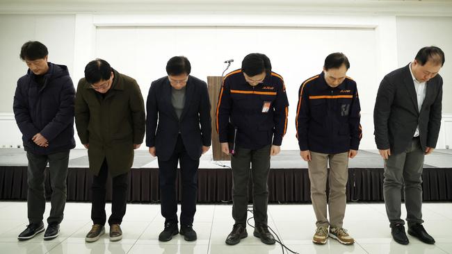 Jeju Air CEO Kim E-bae (3rd-R) and other executive members bow in apology ahead of a briefing in Seoul on December 29, 2024, after a Jeju Air plane carrying 181 people from Thailand to South Korea crashed and burst into flames. Picture: AFP