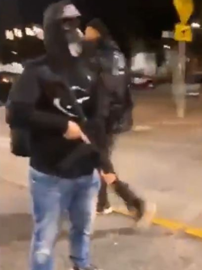 Footage shows guns being handed out to young men in Seattle.