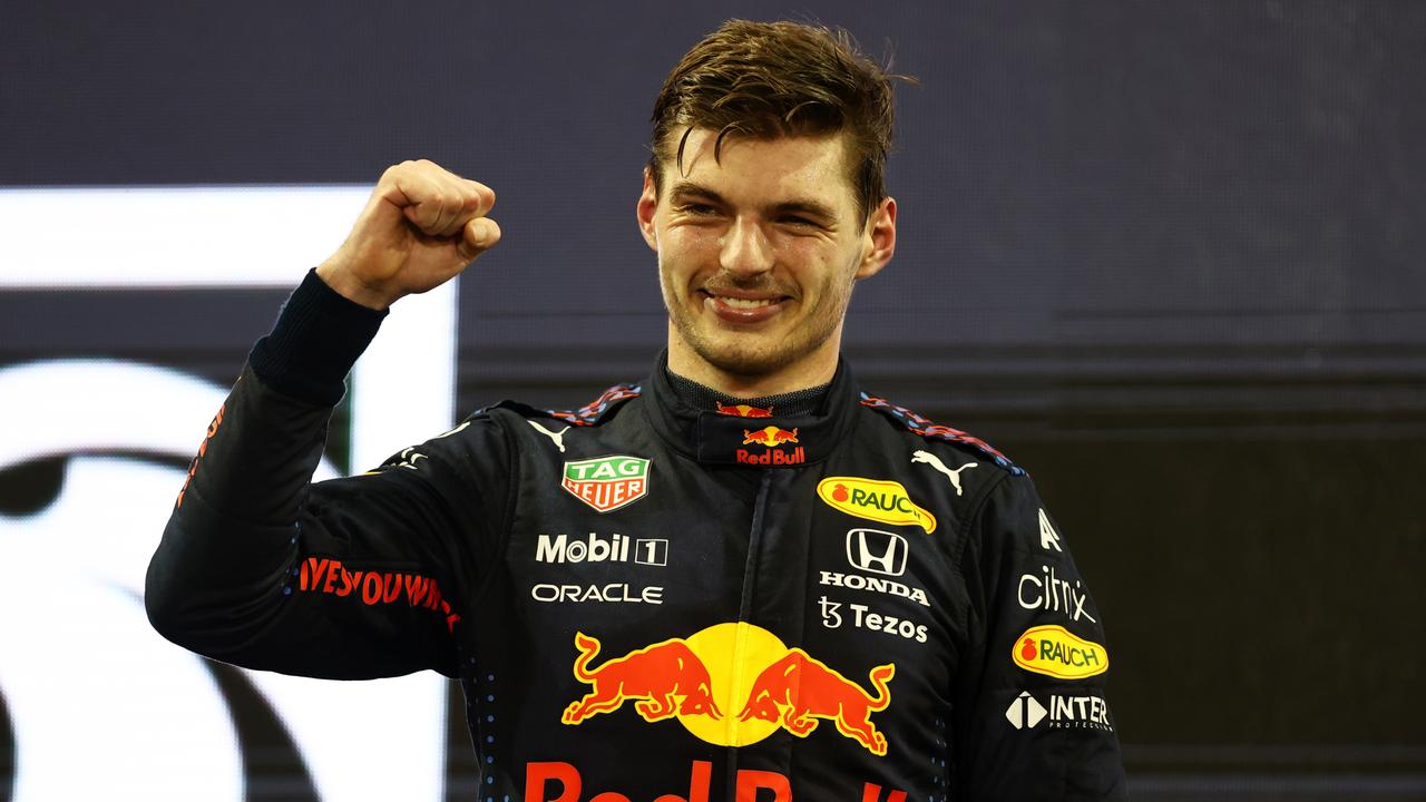 ABU DHABI, UNITED ARAB EMIRATES - DECEMBER 12: Race winner and 2021 F1 World Drivers Champion Max Verstappen of Netherlands and Red Bull Racing celebrates on the podium during the F1 Grand Prix of Abu Dhabi at Yas Marina Circuit on December 12, 2021 in Abu Dhabi, United Arab Emirates. (Photo by Bryn Lennon/Getty Images)