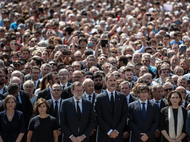 King Felipe VI of Spain and Spanish Prime Minister Mariano Rajoy join other dignitaries and residents of Barcelona in Placa de Catalunya to observe a one minute's silence for the victims. Picture:  Getty