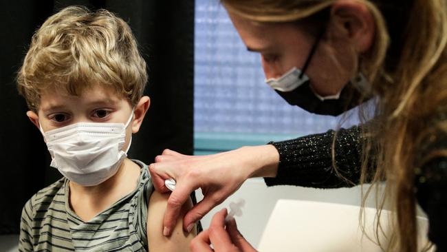 A child receives a dose of the Pfizer vaccine. Picture: AFP