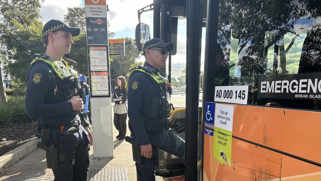 Police officers boarding a bus in the eastern suburbs.