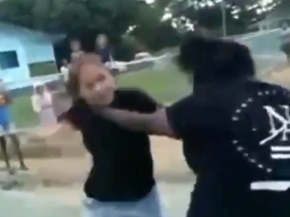 A screenshot of a YouTube video of two women brawling on the streets of Palm Island.