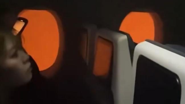 Flames on the tarmac are seen from inside the JAL plane after the crash. Picture: X