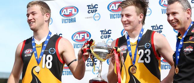 Mitch Riordan (L) and Campbell Hustwaite hold the premiership cup, flanked by Craig Black.