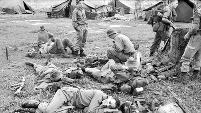 TSoldiers recover after the Battle of Long Tan in Vietnam in 1966.