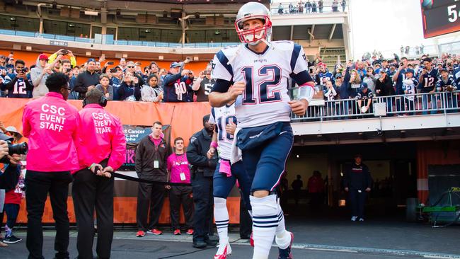 Quarterback Tom Brady #12 of the New England Patriots runs onto the field.