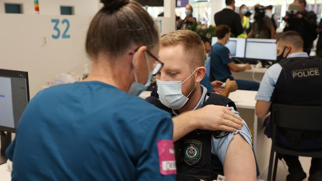 NSW Police officer gets vaccinated at Sydney Olympic Park. Picture: David Swift