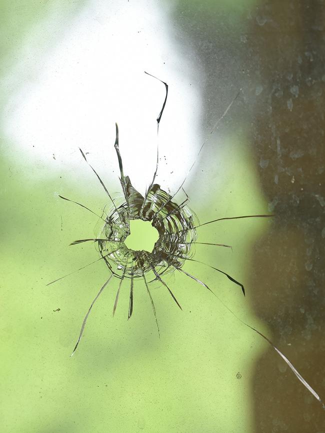 A broken window where the shots were fired. Picture: Lawrence Pinder