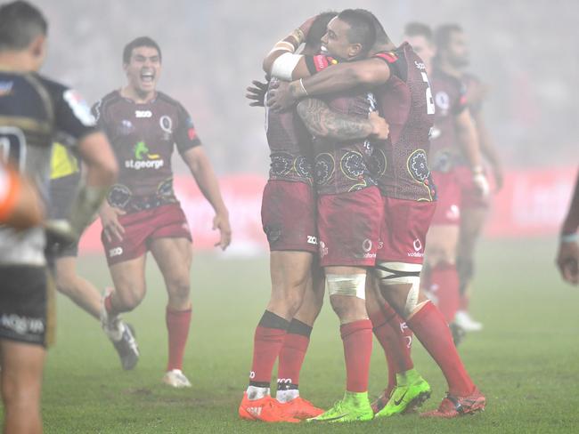 Reds players celebrate after Quade Cooper kicked the winning goal during the round 16 Super Rugby match between the Queensland Reds and the Brumbies at Suncorp Stadium in Brisbane, Friday, July 7, 2017. (AAP Image/Darren England) NO ARCHIVING, EDITORIAL USE ONLY