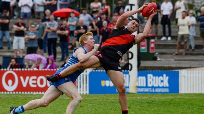 Tea Tree Gully’s Tom Bielby marks ahead of Sacred Heart Old Collegians’ Jared Shattock during the 2020 Adelaide Footy League division two grand final. Picture: Brenton Edwards