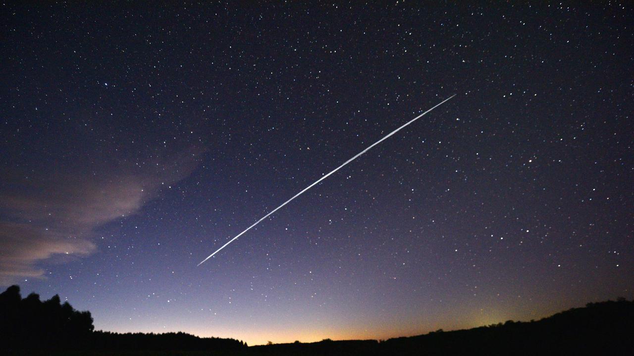 This long-exposure image shows a trail of a group of SpaceX's Starlink satellites passing over Uruguay. Picture: AFP.