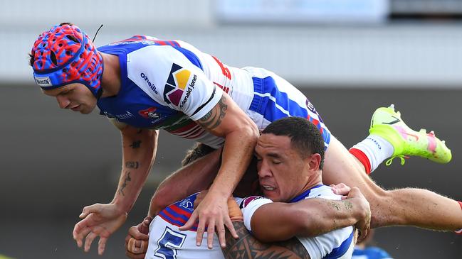 ROCKHAMPTON, AUSTRALIA - SEPTEMBER 12: Kalyn Ponga of the Knights jumps on Hymel Hunt and Tyson Frizell of the Knights as they celebrate Hunt scoring a try during the NRL Elimination Final match between Parramatta Eels and Newcastle Knights at Browne Park, on September 12, 2021, in Rockhampton, Australia. (Photo by Albert Perez/Getty Images)