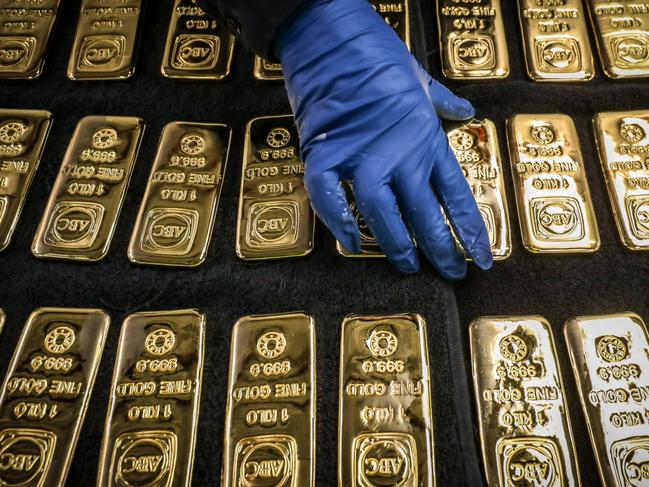 A worker handles ABC Bullion one kilogram gold bars at the ABC Refinery smelter in Sydney, New South Wales, Australia, on Thursday, July 2, 2020. Western investors piling into gold in the pandemic are more than making up for a collapse in demand for physical metal from traditional retail buyers in China and India, helping push prices to an eight-year high. Photographer: David Gray/Bloomberg