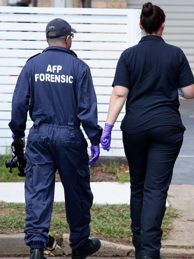 AFP officers at a home on South Liverpool Rd in Hinchinbrook on Wednesday. Picture: Jonathan Ng