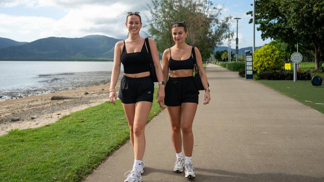 Lily Watson and Angelina Ridolini of the UK soak up some sunshine on the Cairns Esplanade ahead of their working holiday in Cairns. Picture Emily Barker.