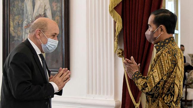 Indonesian President Joko Widodo, right, welcomes Jean-Yves Le Drian to during the presidential palace in Jakarta on Wednesday. Picture: AFP