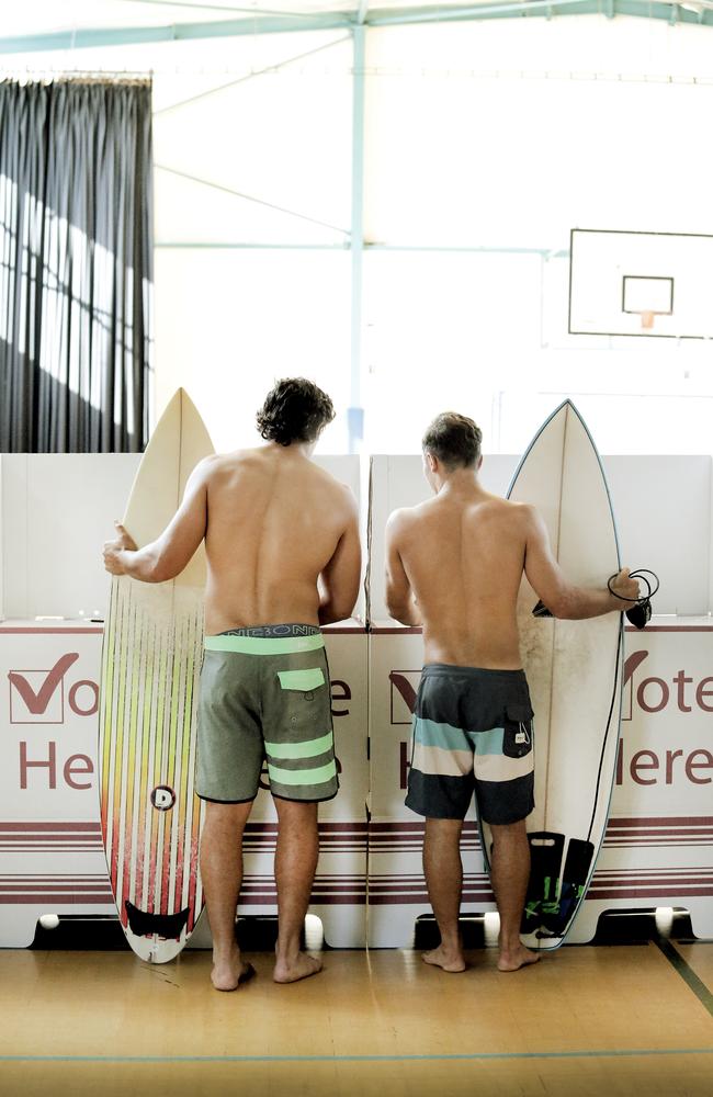 Surfers Dylan Riley and Hayden Sargeant vote on the way to Mermaid Beach. Pic by Luke Marsden.