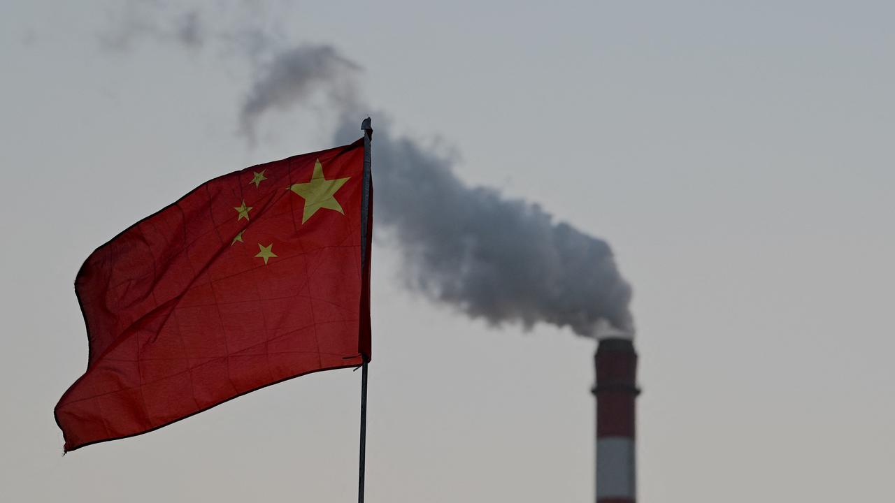 China's national flag flutters in front of a coal-powered power station in Datong. Picture: Noel Celis / AFP