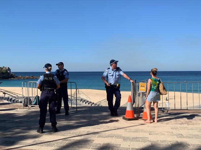 Police at the entrance of Coogee Beach after lifeguards closed the stretch of sand today. Picture: Wendy Fitzgibbon