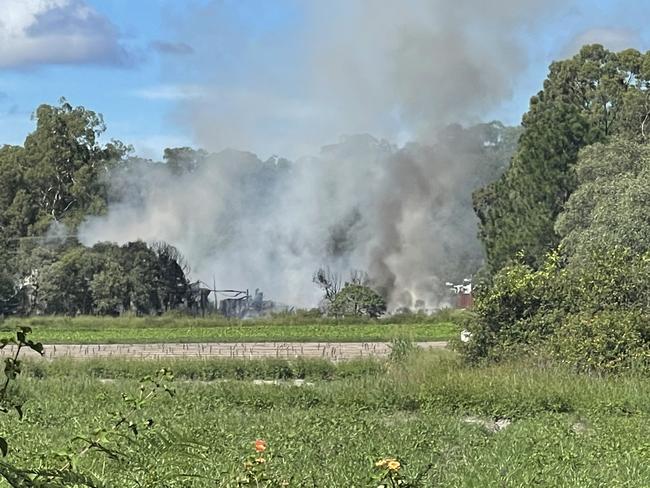 More than 50 firefighters, including fire investigations units, are still on scene at Koplick St, Park Ridge after the fire destroyed a shed full of tyres and oil drums. Picture: Brayden Heslehurst