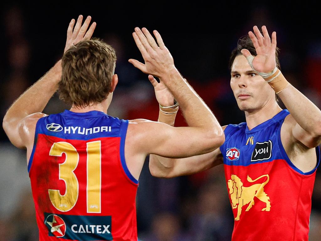 Eric Hipwood of the Lions celebrates a goal with teammate Harris Andrews. (Photo by Dylan Burns/AFL Photos via Getty Images)