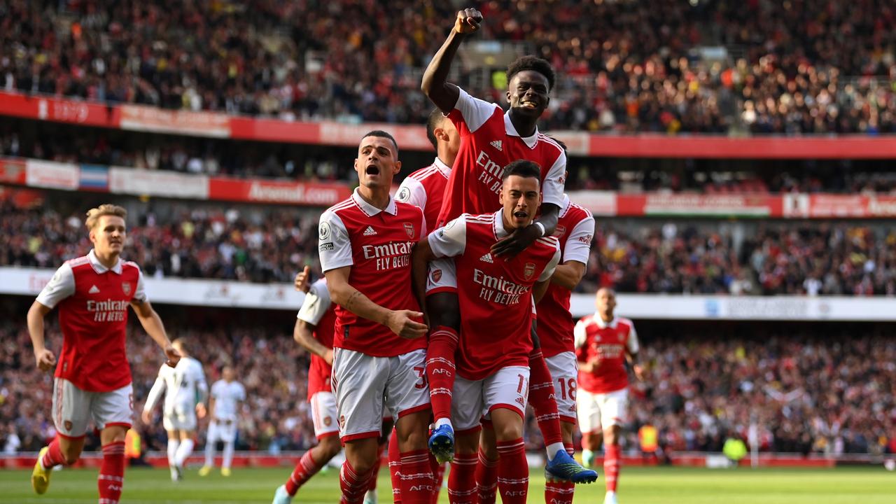 Gabriel Martinelli of Arsenal celebrates with teammates after scoring their team's first goal during the Premier League match between Arsenal FC and Liverpool FC.