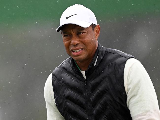 (FILES) In this file photograph taken on April 8, 2023, Tiger Woods of the US reacts on the 18th green during the continuation of the weather delayed second round of the 2023 Masters Tournament at Augusta National Golf Club in Augusta, Georgia. - Five-time winner Tiger Woods, who limped through an awful, bogey-strewn start to his rain-halted third round of the Masters, pulled out of the tournament with a foot injury organizers said on aPRIL 9, 2023. (Photo by ROSS KINNAIRD / GETTY IMAGES NORTH AMERICA / AFP)