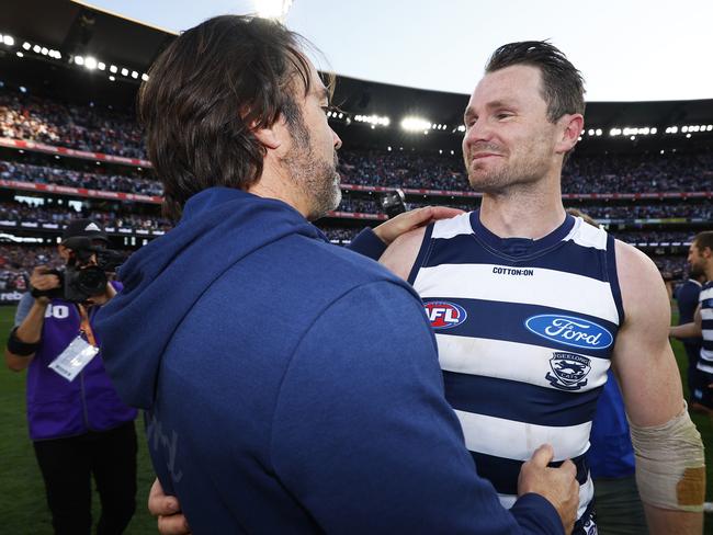 MELBOURNE, AUSTRALIA - SEPTEMBER 24: Patrick Dangerfield of the Cats and Cats head coach Chris Scott celebrate winning the 2022 AFL Grand Final match between the Geelong Cats and the Sydney Swans at the Melbourne Cricket Ground on September 24, 2022 in Melbourne, Australia. (Photo by Daniel Pockett/AFL Photos/via Getty Images)