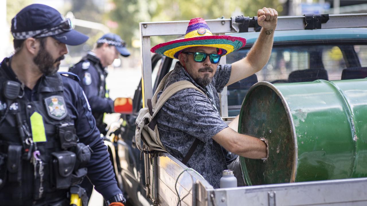 Another activist stuck in a drum of cement is taken away by police. Picture: AAP