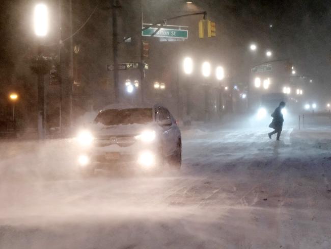 Traffic moves through lower Manhattan in the pre-dawn hours as a winter storm brings heavy snow, freezing temperatures and blowing winds. Picture: Getty