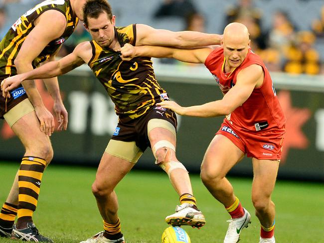 Hodge and Ablett battle for the ball in 2012.