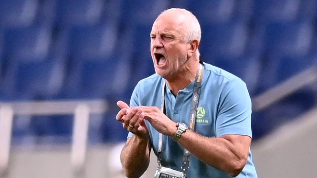 Australia's head coach Graham Arnold speaks to his players during the 2022 Qatar World Cup Asian Qualifiers group B football match between Japan and Australia, at Saitama Stadium in Saitama, on October 12, 2021. (Photo by CHARLY TRIBALLEAU / AFP)