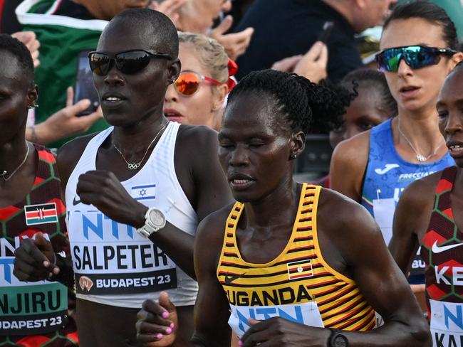 (FILES) (From L to R) Kenya's Rosemary Wanjiru, Israel's Lonah Chemtai Salpeter, Uganda's Rebecca Cheptegei and Kenya's Selly Chepyego Kaptich compete in the women's marathon final during the World Athletics Championships in Budapest on August 26, 2023. A Ugandan marathoner who competed at the Paris Olympics is in intensive care after  being set on fire alledgedly by her partner in Kenya, officials said on September 3, 2024, the latest horrific incident of gender-based violence in the East African country. Long-distance runner Rebecca Cheptegei, 33, was assaulted after her Kenyan partner Dickson Ndiema Marangach reportedly snuck into her home in western Trans-Nzoia county on September 1, 2024 at around 2:00 pm while she and her children were at church, police said. (Photo by Ferenc ISZA / AFP)