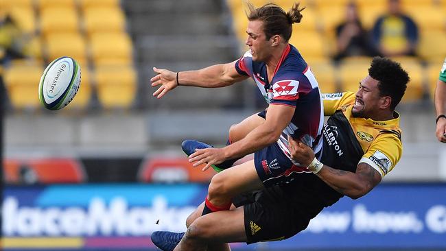 Rebel Ben Meehan hands off during the weekend’s slaughter at the hands of Ardie Savea and the Hurricanes. Picture: Getty Images