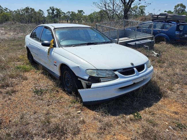 Unregistered, white, 4-door, Holden Commodore sedan.