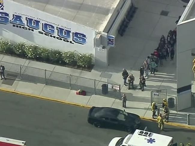 People are lead out of Saugus High School after reports of a shooting. Picture: AP